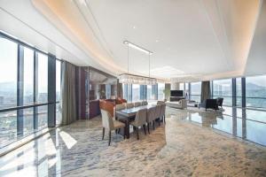 LONGYAN JINGHUA FLIPORT HOTEL في لونغيان: غرفة طعام بها طاولة وكراسي