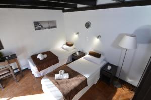 a hotel room with two beds and a lamp at Sunny views studios in Agios Gordios +54 photos