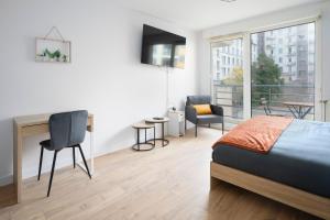 a bedroom with a bed and a desk and a window at Le Cocon Lyonnais in Lyon