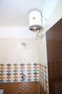 a bathroom with a shower with a checkered floor at Hotel Yog Tapovan in Rishīkesh