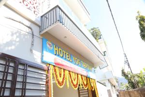 a hotel room with a balcony on the side of a building at Hotel Yog Tapovan in Rishīkesh