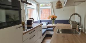 a kitchen with a sink and a counter top at The Pelican in Warmenhuizen