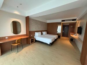a hotel room with a bed and a television at WYNS Hotel Bandung in Bandung +37 photos
