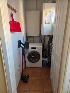 a washer and dryer in a small room at Ferienhaus Seemöwe mit Deichblick Butjadingen-Burhave in Burhave +21 photos