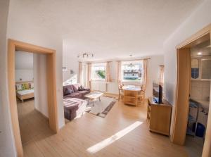 a living room with a couch and a table at LechBrugger Berg Appartements in Holzgau