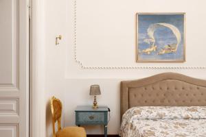 En eller flere senge i et værelse på Elegante appartamento d'epoca nel centro di Trieste