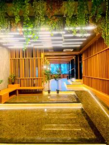 a lobby of a building with plants on the ceilings at WYNS Hotel Bandung in Bandung