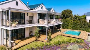 an aerial view of a house with a deck and a swimming pool at Stanford Riverside Retreat - Hotub & Pool in Stanford