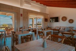 a restaurant with tables and chairs and a view at Agroturismo Son Vives Menorca - Adults Only in Ferreries