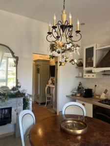 a dining room with a table and a chandelier at Casa Veranda sul mare in Gela