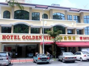 Un cartel de visa dorada de hotel frente a un edificio en Jin Hotel, en Kampong Kuchai
