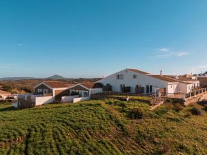 a house on top of a grassy hill at Agroturismo Son Vives Menorca - Adults Only in Ferreries