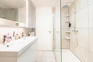a white bathroom with a shower and a sink at Weinblick Sauna-Infrarot 2 Schlafzimmer in Saarburg +44 photos