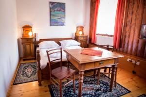 a dining room with a table and two beds at Guest House Gostišče Gačnk V Logu in Cerkno