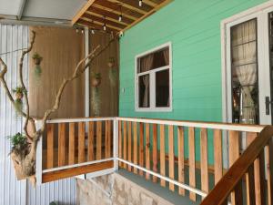 a front porch of a blue house with a window at MOre home 2 - ngôi nhà nghĩ dưỡng tại Đà Lạt in Da Lat