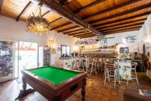 a pool table in a room with a bar at Residence Fium Del Cavo in Sainte-Lucie de Porto-Vecchio