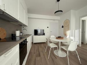 a kitchen with a table and chairs in a kitchen at MH Lippolis in Bari