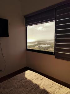 a room with a window with a view of a field at Apartment on Margarita Island edif Lagunablanca Apto 1201 in Porlamar