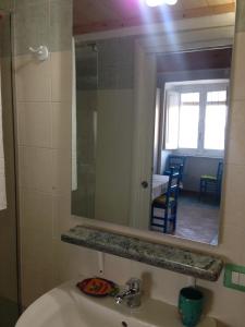 a bathroom with a sink and a mirror at La Casa di Titina in Procida