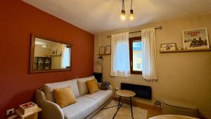 a living room with a white couch and a mirror at Flor de Hielo in Candanchú +7 photos