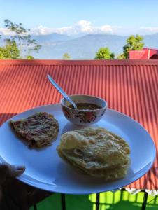a plate of food with a bowl of soup and biscuits at Kanchenjunga Vista Pabong in Sāmthar
