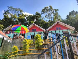 a house with a colorful umbrella in front of it at Kanchenjunga Vista Pabong in Sāmthar