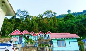 a row of houses with a car parked in front at Kanchenjunga Vista Pabong in Sāmthar