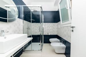 a bathroom with a toilet and a sink and a shower at Ungaretti Resort in Porto Cesareo +27 photos