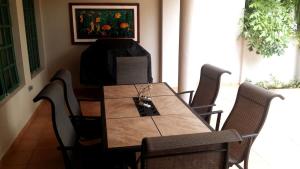 a dining room table with chairs and a painting on the wall at Villa Arrecife Community Pool w Ocean View in Dorado +27 photos