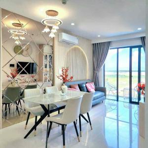 a dining room with a table and a blue couch at Tom's House Apartment 1 in Thôn Văn Dương