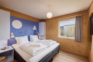 a bedroom with two beds and a window at Center Parcs Nordborg Resort in Nordborg +74 photos