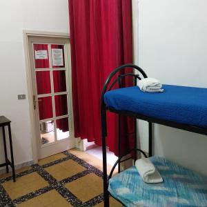 a room with two bunk beds and a window at Sahary in Naples