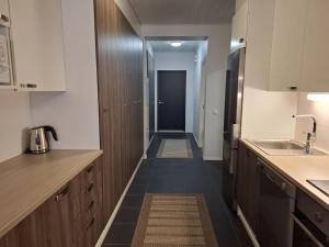 a kitchen with a hallway leading to a door at Starvillas B201 in Kalajoki
