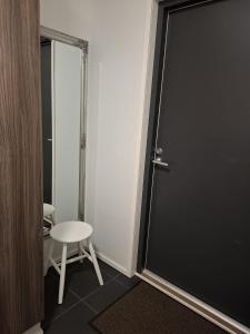 a door in a room with a stool and a chair at Starvillas B201 in Kalajoki +4 photos