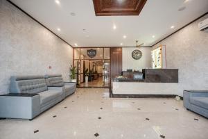 a lobby with couches and a counter in a building at Kayalresidency in Gopichettipālaiyam