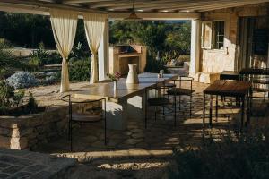 a patio with a table and chairs on a patio at Regina di Ulivi in Ostuni