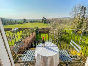 Una botella de vino sentada en una mesa en un balcón en The Clock Tower, en Daventry