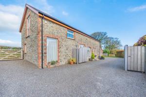 an exterior view of a brick building with a fence at 3 Bed in Llanddarog oc-p30291 in Llanddarog