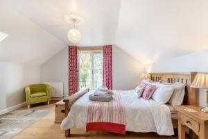 a bedroom with a bed and a green chair at 3 Bed in Llanddarog oc-p30291 in Llanddarog +30 photos
