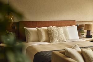 a bedroom with a large bed with pillows at 1 Hotel Tokyo in Tokyo