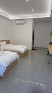 Ένα ή περισσότερα κρεβάτια σε δωμάτιο στο 崇安精品酒店