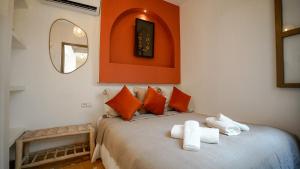 a bedroom with a bed with two towels on it at Riad Alaya, Rooftop Pool & Koutoubia View in Marrakesh