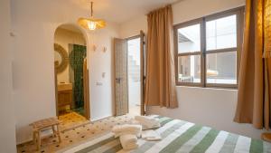 a bedroom with a bed and a large window at Riad Alaya, Rooftop Pool & Koutoubia View in Marrakesh