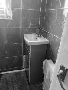 a black and white bathroom with a sink at High class accommodations 10 in Little Hulton