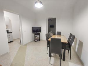 a dining room with a table and chairs and a television at Dimora del Centro in Marsala +13 photos