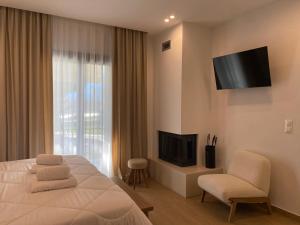 カト・ルートラキにあるLithosのベッドとテレビがあるホテルの部屋