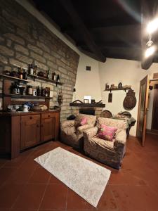 a living room with a couch and a brick wall at Cascina Montalbano in Rosignano Monferrato