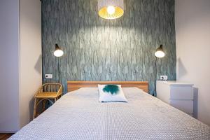 En eller flere senge i et værelse på La Maison et son jardin clos