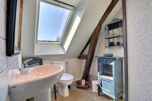 a bathroom with a sink and a toilet and a window at Appart' d'hôtes , ch et gîte au Manoir de la Haute Pilais in Chantepie +19 photos
