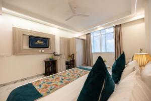 a hotel room with a bed and a television at Hotel East End Delhi Airport in New Delhi